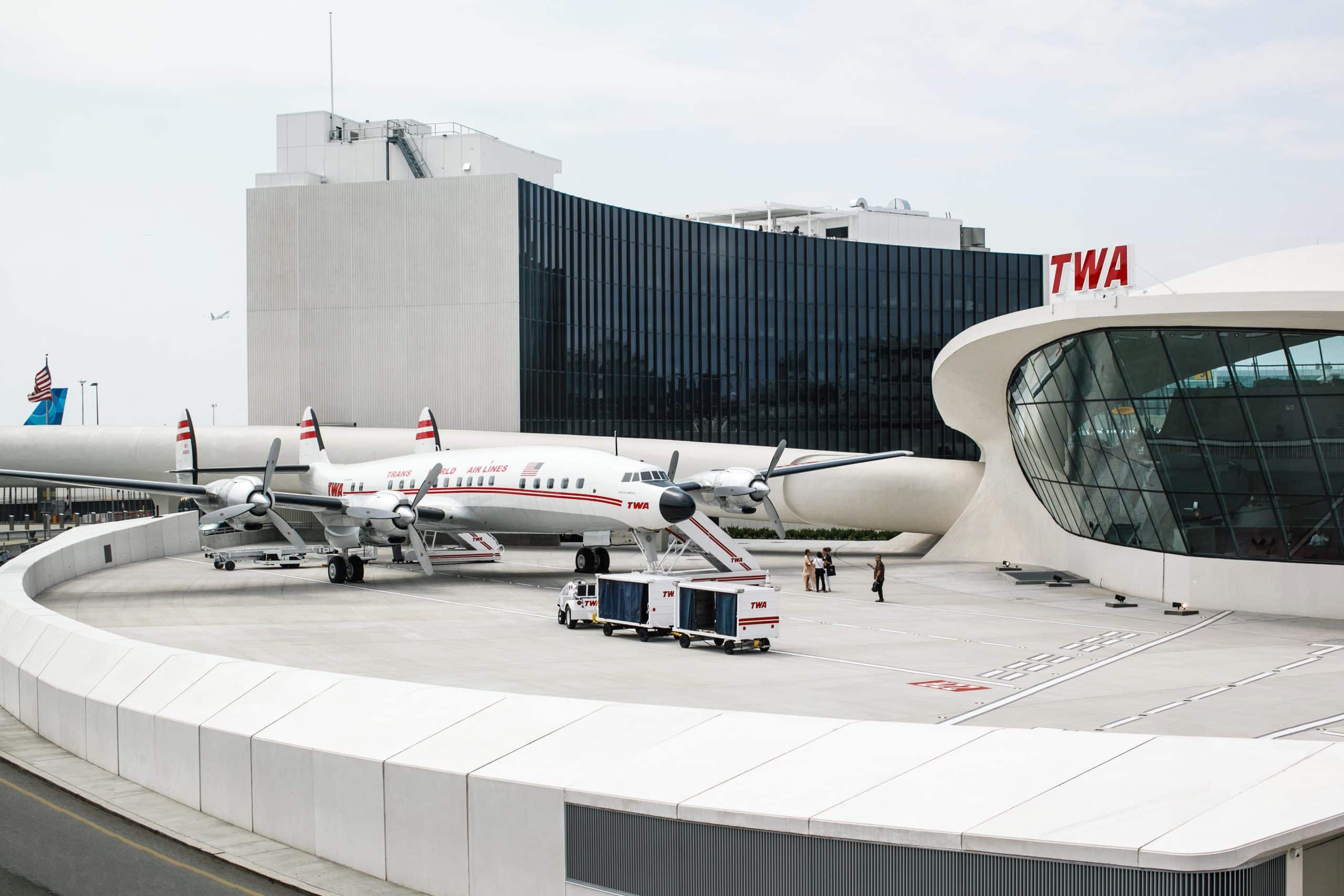 TWA Hotel exterior, with an original TWA plane that has been turned into a cocktail bar.
