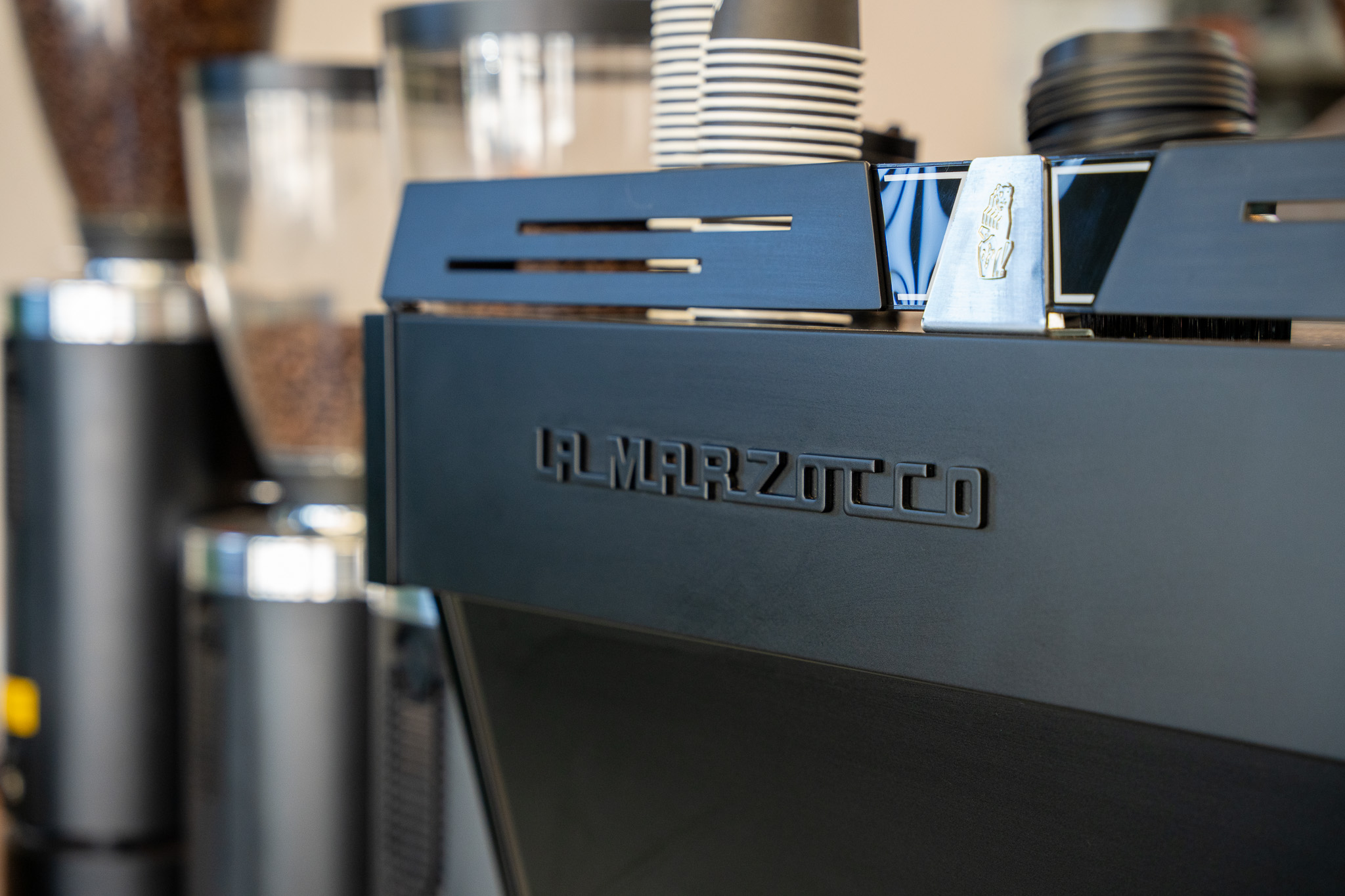 the back of a linea pb showing the la marzocco logo and lion icon