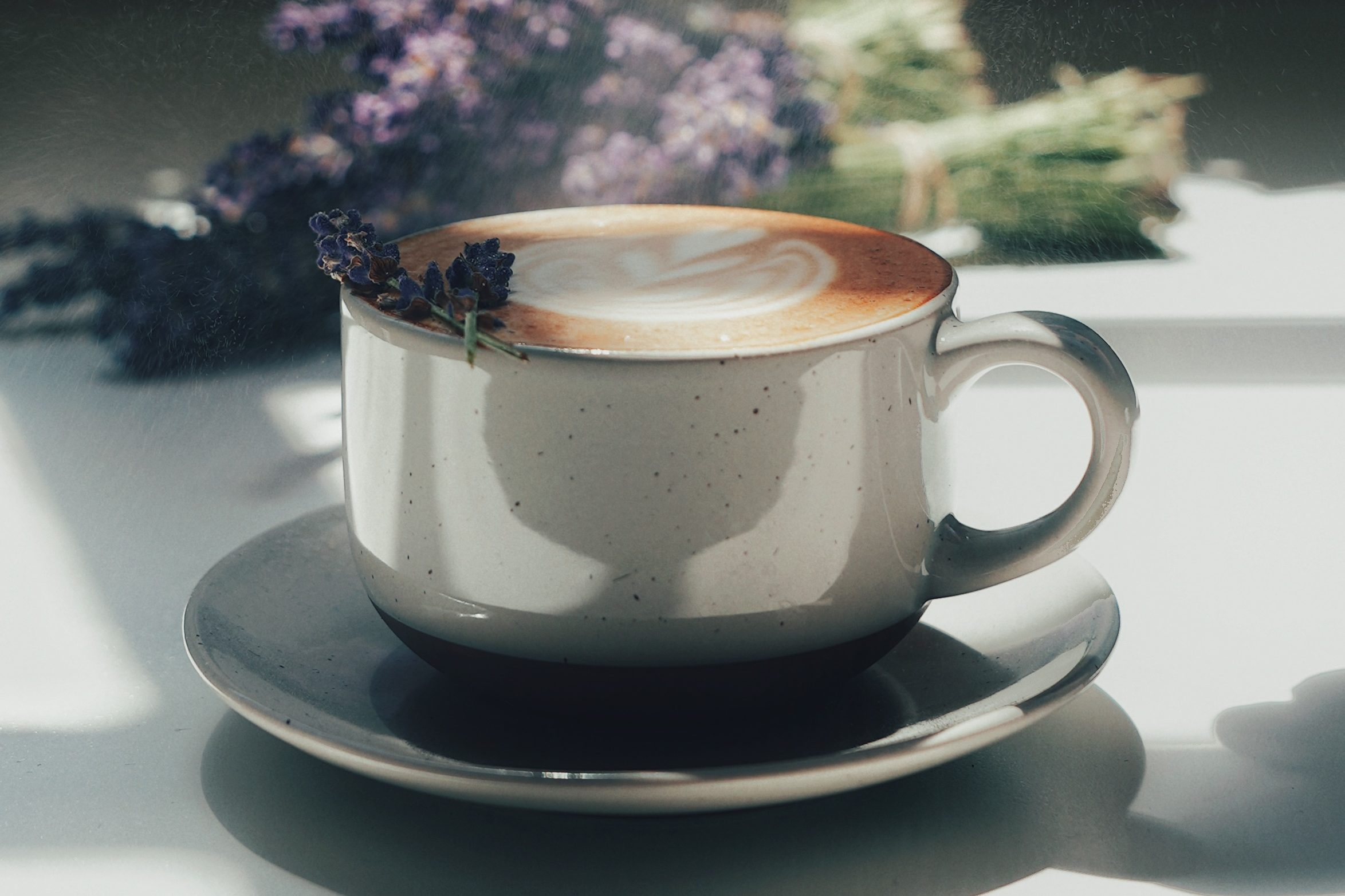 a close up of a lavendar latte