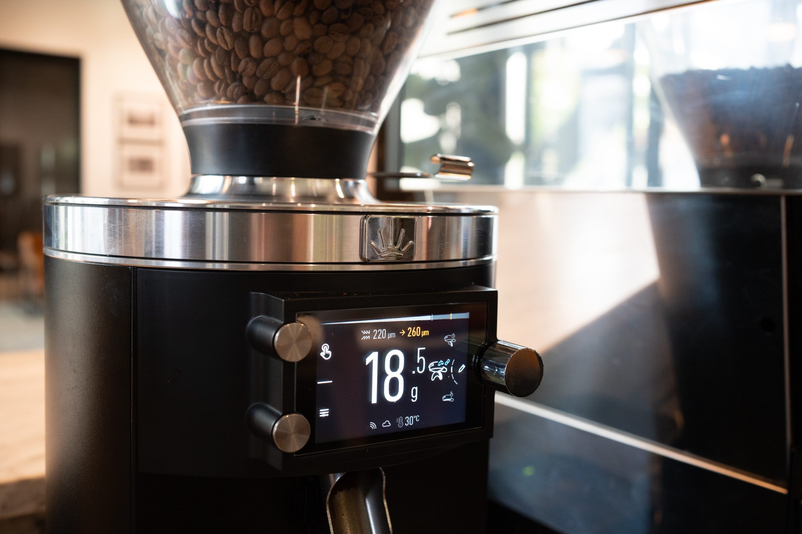 a close up display of an espresso grinder showing coffee dose weight and burr distance