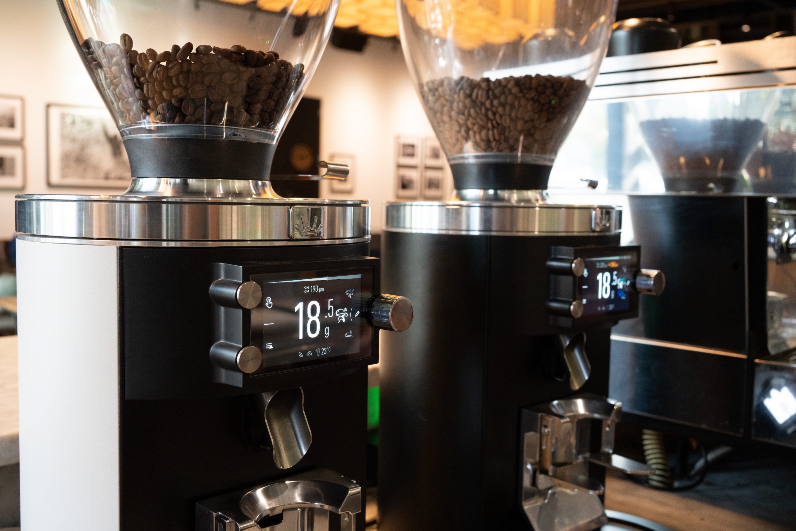 two espresso grinders on a coffee bar side by side