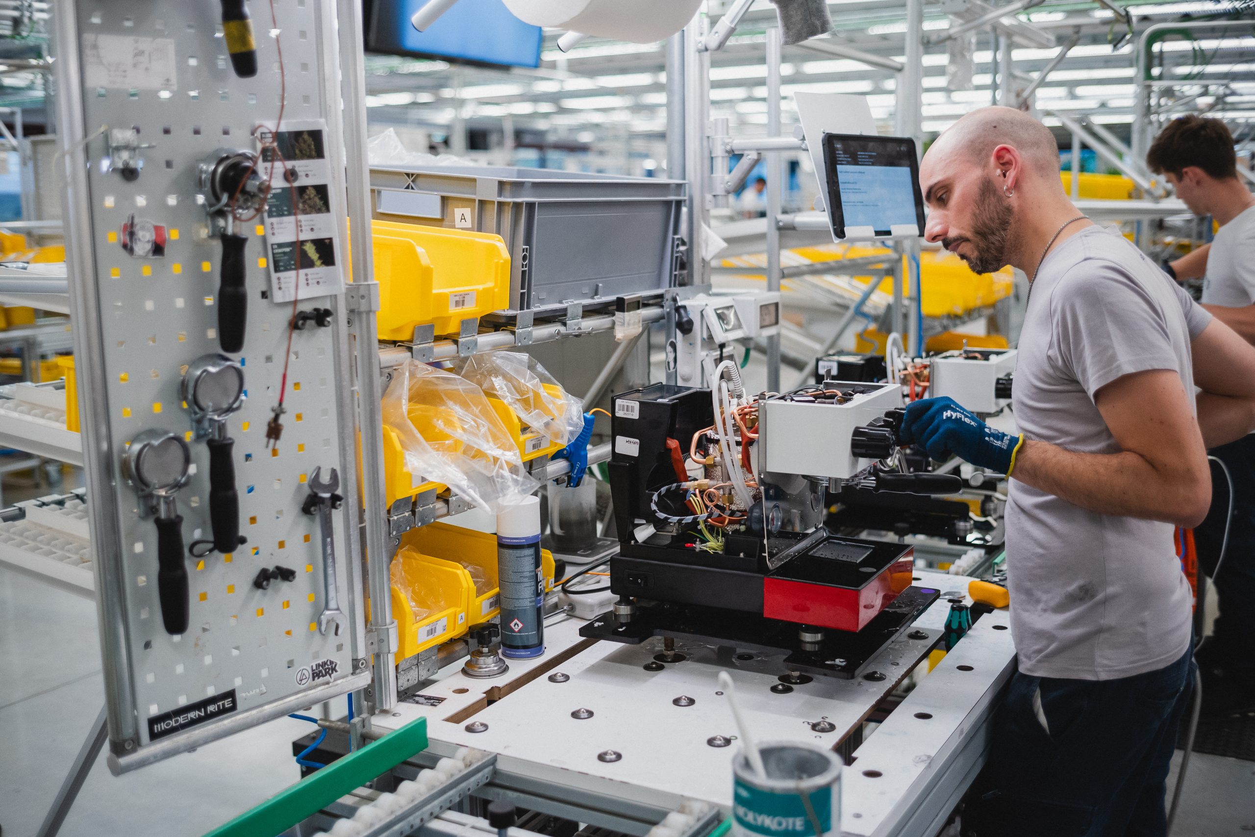 a la marzocco artisan assembling a linea micra at a production station