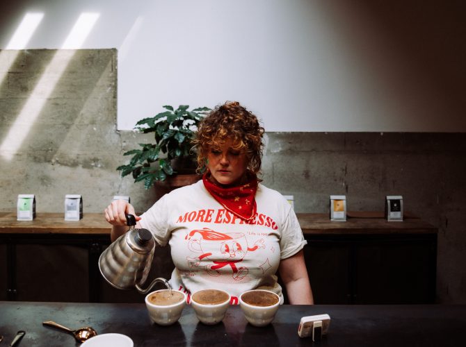 a woman preparing a flight of coffees for cupping