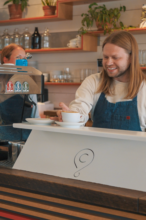 Barista serving coffee