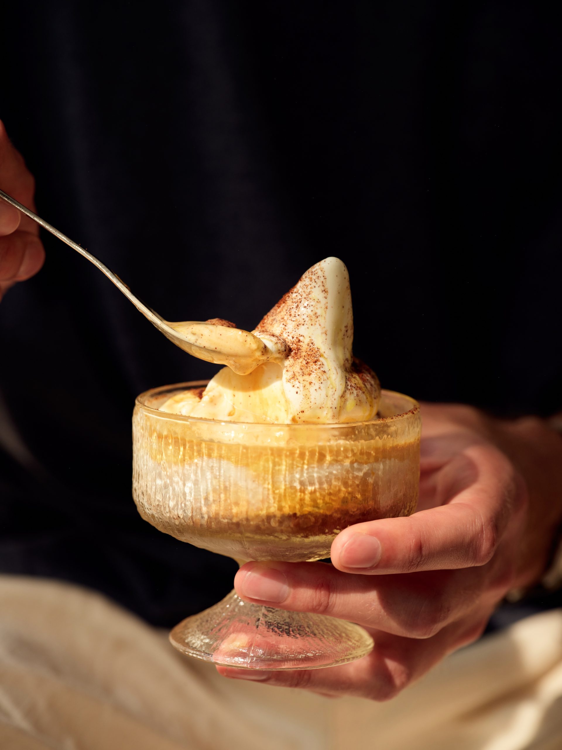 a side view of an affogato scooping up espresso and ice cream onto a spoon
