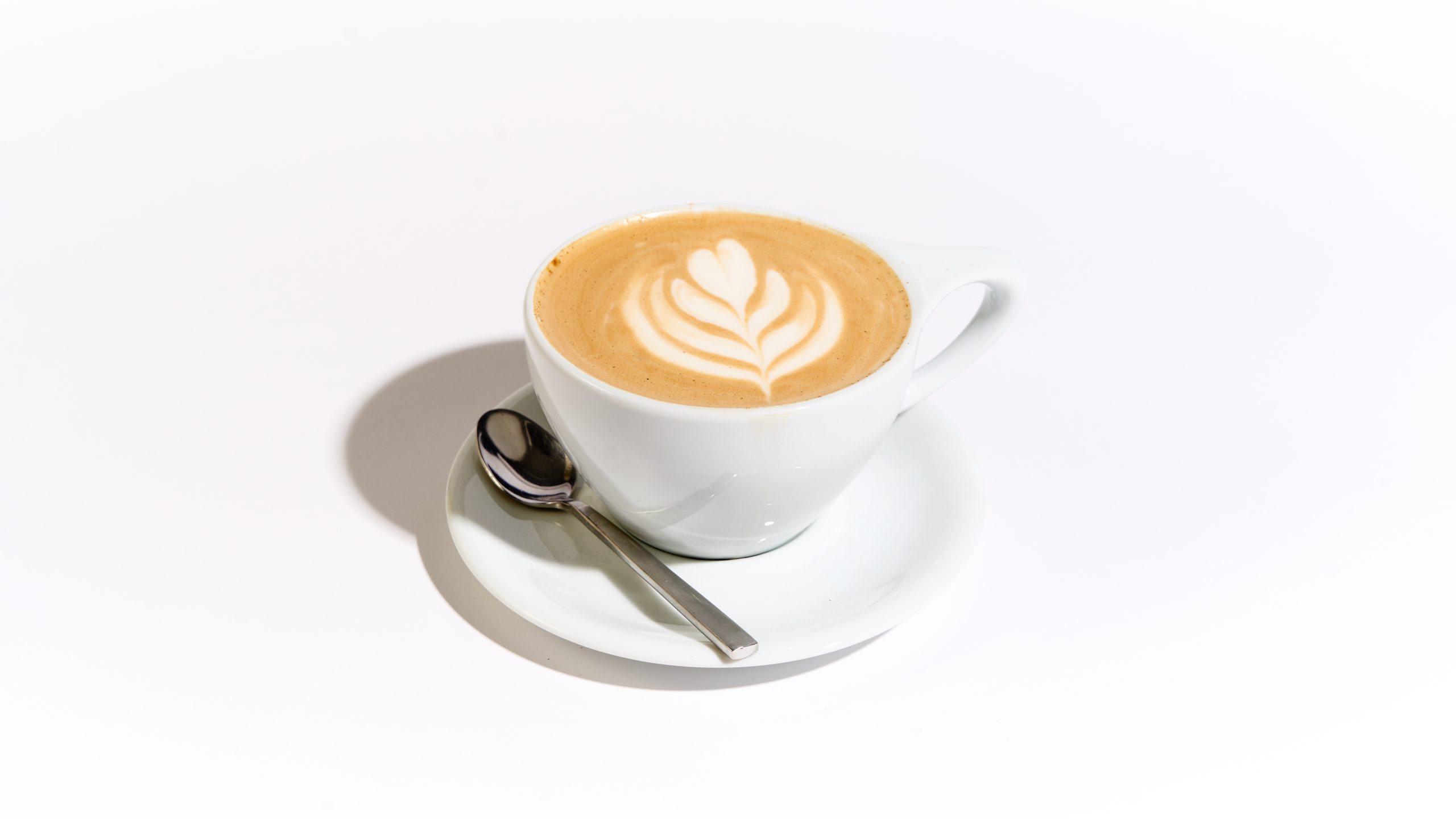 a pumpkin spice latte in a white mug