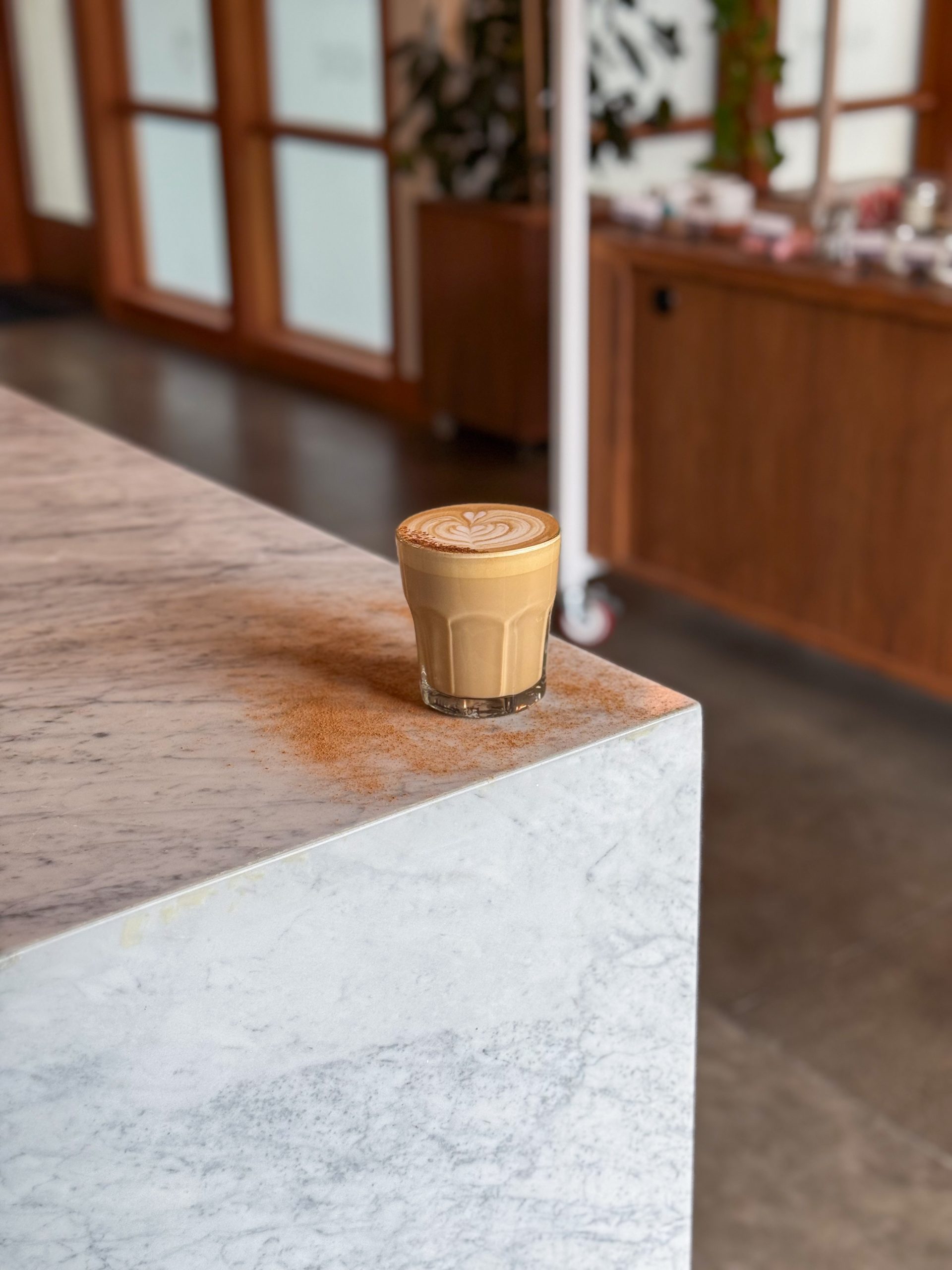 a Spice Pumpkin Latte in a rocks glass on the corner of a counter