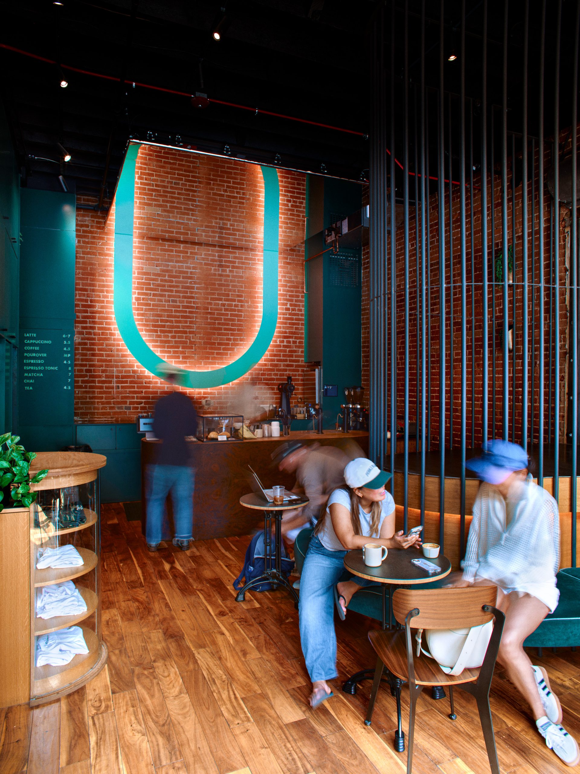the interior of slow by slow feautring wood panelling and curved wood dowels